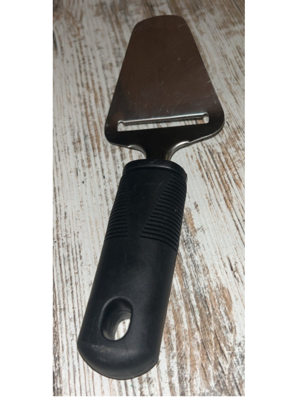 cheese plane, also known as a cheese slicer or ostehøvel.